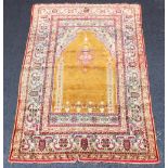 A Caucasian silk work prayer rug, the arcaded central panel with stylised hanging lantern