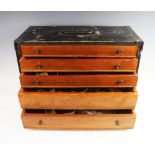 A collection of watch parts and effects, to a painted wooden five drawer specimen chest, to