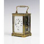 A late 19th century French brass carriage clock, the 7cm enamelled white dial applied with Roman
