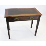 An early 20th century Arts and Crafts oak writing table, the leather inset rectangular moulded top