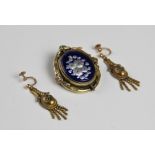 A pair of late Victorian drop earrings, each of tapering form with a floral decoration oval panel