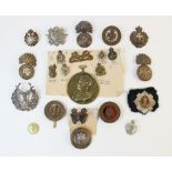 A collection of British military badges and insignia, to include badges for the Queen's Own Hussars,