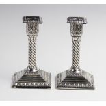 A pair of Victorian silver weighted desk candlesticks by Jacob Berman, London, one dated 1888, the