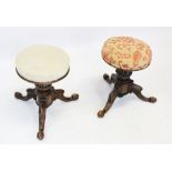 A pair of Victorian walnut adjustable piano stools, each with a circular revolving upholstered
