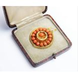 A Victorian coral set memorial target brooch, the central panel designed as a six petal flower