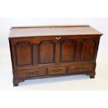 A George III oak mule chest, the rectangular hinged top above four fielded panels flanked by