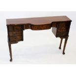 A burr walnut side table, circa 1930, later reconstructed from a dressing table, with a single bow