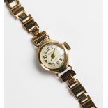 A vintage lady's 9ct Regency wristwatch, the round cream with with Arabic numerals, set to a round