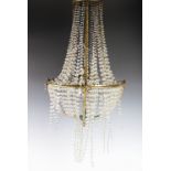 A French early 20th century gilt brass basket chandelier, with ribbon and bow decoration, four light
