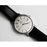 A gent's vintage Omega Automatic stainless steel wristwatch, the round silvered dial with baton
