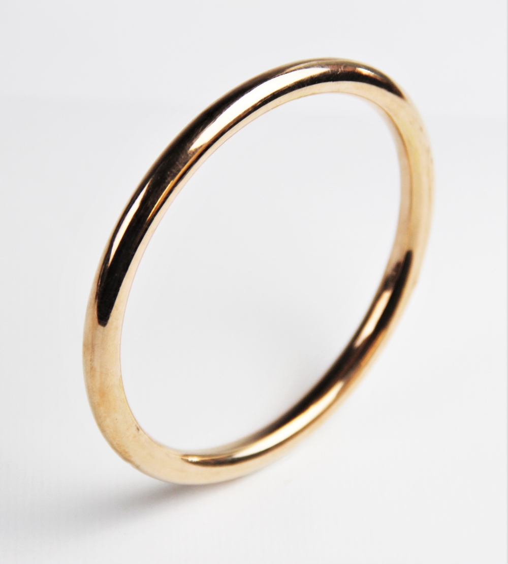 A 9ct gold tubular slave bangle by S Ward & Sons, Chester 1920, 9cm diameter, weight 16.7gms