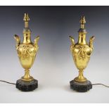 A pair of Regency style decorative lamp bases, each designed as a baluster vase modelled with