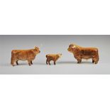 A Beswick Highland cattle family, comprising; a bull, cow and calf, each with printed maker's