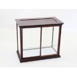 A late 19th/early 20th century mahogany glazed counter top display cabinet, the moulded cornice