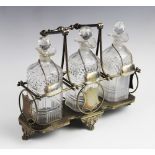 A three bottle tantalus, comprising three cut glass decanters, each 21cm high, each with a white