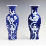A pair of late 19th century Chinese blue and white prunus pattern vases, each of baluster form and