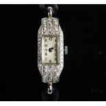 An Art Deco diamond set platinum wristwatch, the rectangular cream with Arabic numerals, set to a