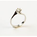 A diamond solitaire ring, comprising a central round brilliant cut diamond weighing an estimated 0.