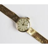 A lady's vintage 9ct gold Garrard wristwatch, the round cream dial with baton markers, set to a