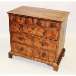 An early 18th century and later walnut chest of drawers, the quarter veneered cross banded top above