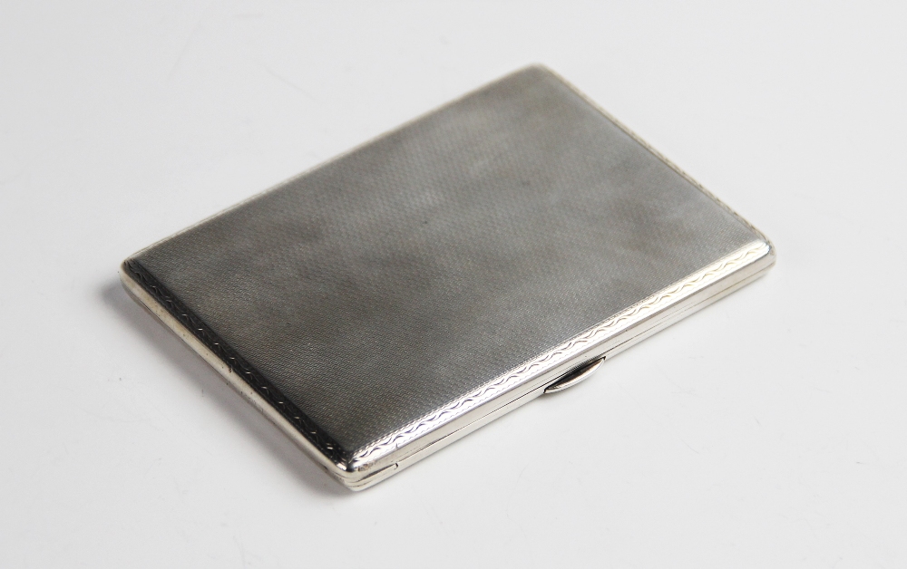 An Art Deco silver cigarette case, of rectangular form with engine turned decoration to exterior,