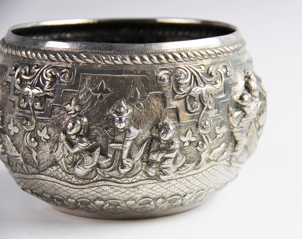 A late 19th/early 20th century Burmese white metal bowl, of circular form decorated in high relief - Image 4 of 6