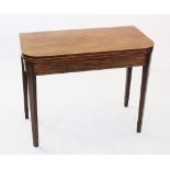 An early 19th century mahogany folding tea table, the 'D' shaped top outlined with inlaid stringing,