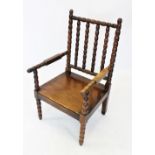 A 19th century oak bobbin turned open armchair, with a board seat enclosed by bobbin turned rails,