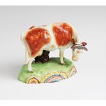 A Staffordshire pearlware cow in the manner of Obadiah Sherratt, early 19th century, modelled