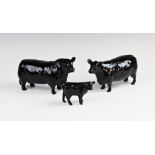 A Beswick Aberdeen Angus cattle family, comprising; a bull, cow and calf, each with printed maker'