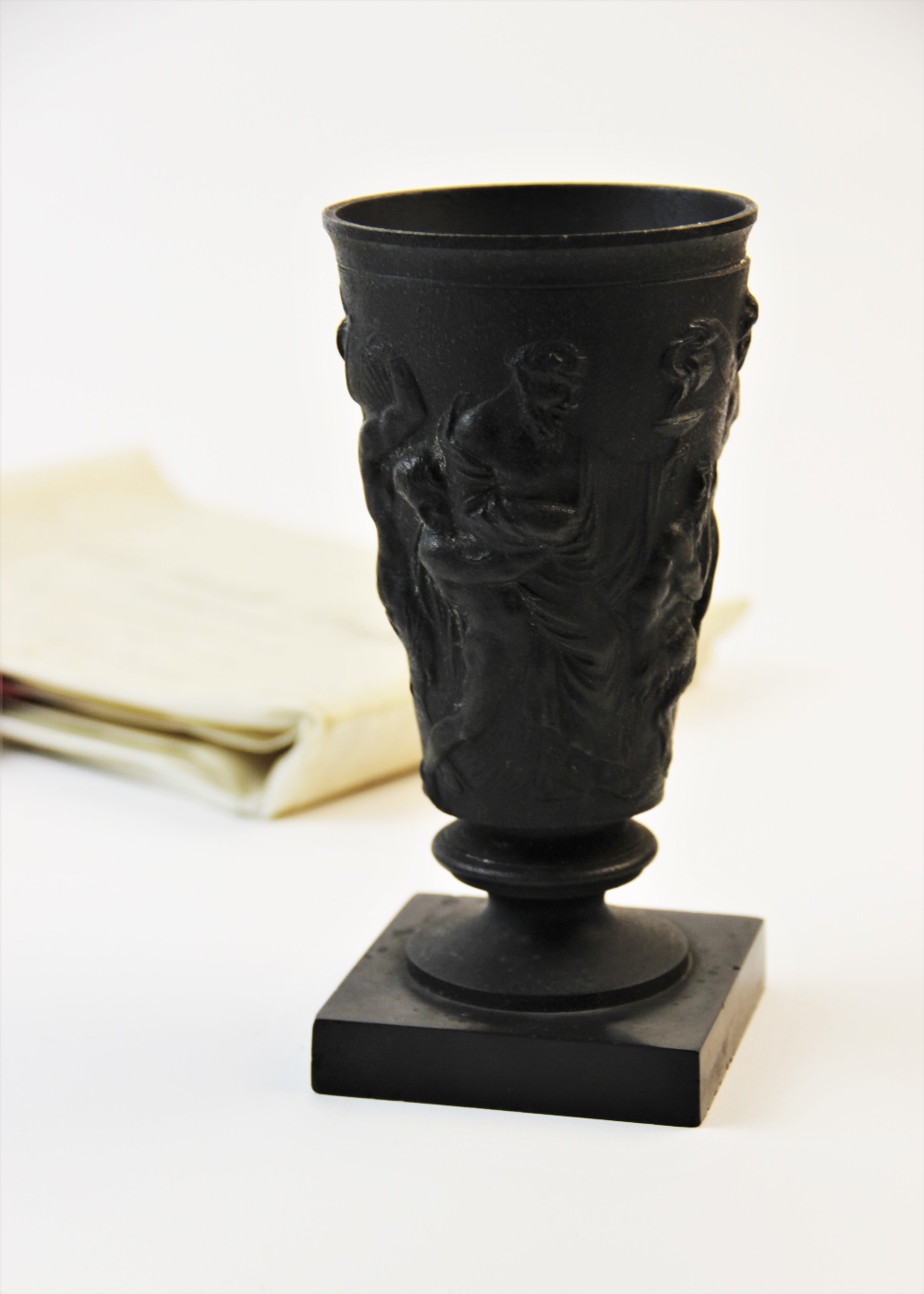 A cast metal goblet, 19th century, decorated with a relief moulded scrolling frieze depicting a - Image 4 of 6