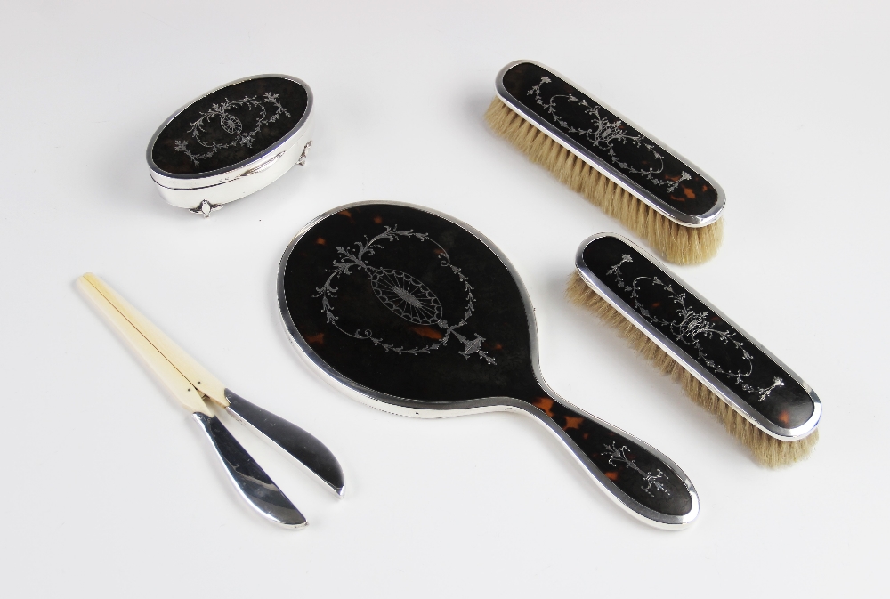 A George V silver and tortoiseshell pique work dressing table set, Walker & Hall, Birmingham 1921,