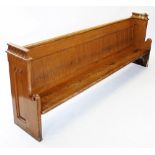 A Victorian pitch pine church pew, the end supports with a pagoda type top rail above Gothic