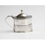 An Edwardian silver wet mustard by Goldsmiths & Silversmiths Co, London 1903, of oval form with