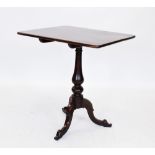 A George III mahogany tripod table, the rectangular tilt top raised upon a baluster pedestal,