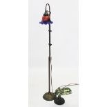 A brass floor standing adjustable reading lamp with a Tiffany style mottled glass shade, 141.5cm