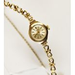 A lady's 9ct vintage 'Kered' wristwatch, the circular silver dial with baton markers, set to a plain
