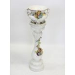 A Capodimonte style jardinière and stand, each with large scale floral encrusted spray motif to