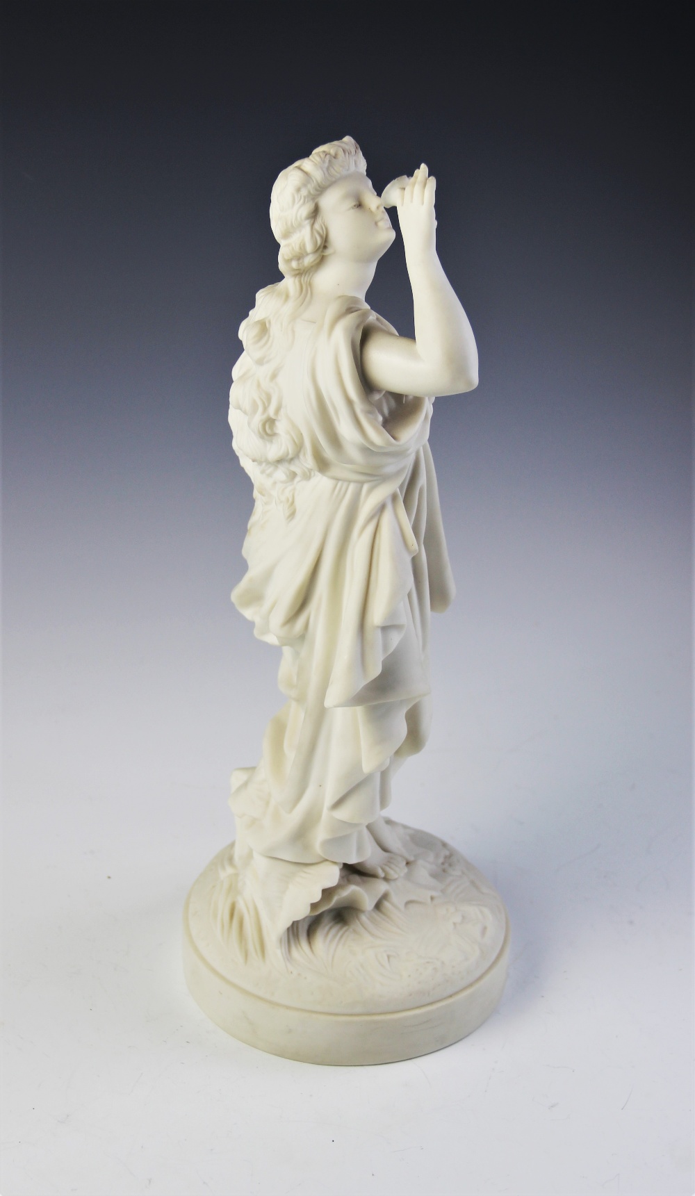A Parian ware figure of a flower picker, modelled standing with her hand aloft smelling a flower, - Image 4 of 4