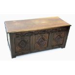 A late 17th century carved oak coffer, the moulded two plank top above a frieze carved with