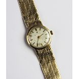 A lady's vintage 9ct gold Omega wristwatch, the circular silver dial with baton markers set to a