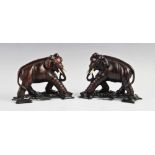 A pair of Chinese carved hardwood figured of bull elephants, each realistically modelled with