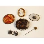 A selection of Victorian and later brooches and pins, to include an oval chalcedony example with a