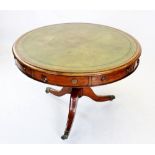 A mid 19th century mahogany library drum table, the circular moulded top inset with a gilt tooled