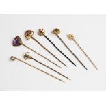 A selection of seven gold and yellow metal stick pins, to include a 14ct gold amethyst set