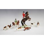 A Beswick hunting group comprising; a huntsman on a rearing horse, model 868, 24.5cm high, a girl on