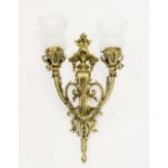 An Edwardian twin branch gilt brass wall sconce, converted from gas, with two branches issuing from