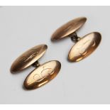 A pair of 9ct gold cufflinks, each of of oval form with engraved initials 'F' and 'G', each panel