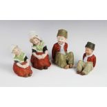 Two graduated pairs of Gebruder Heubach Dutch children, each modelled seated with their hands upon