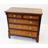 A George III oak and mahogany cross banded chest of drawers, the rectangular cross banded and